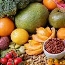 Vibrant assortment of fresh fruits, vegetables, and nuts, representing healthy nutrition.